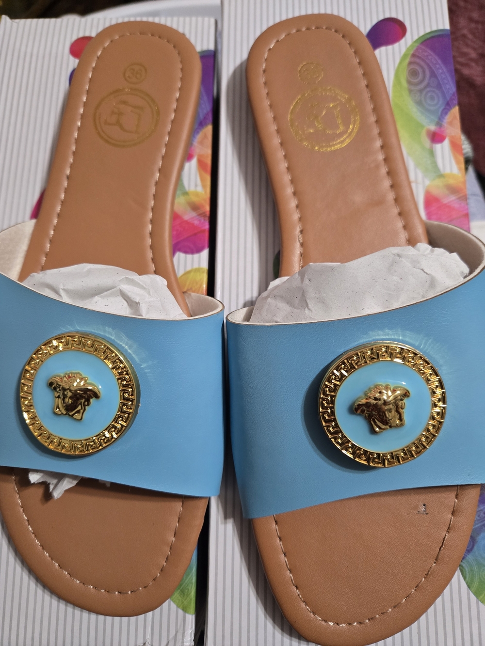 Light Blue Slip-On Women's Sandals with Gold Medallion Accent